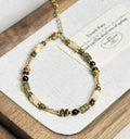 Pulsera con ágata negra y ojo de tigre en concha