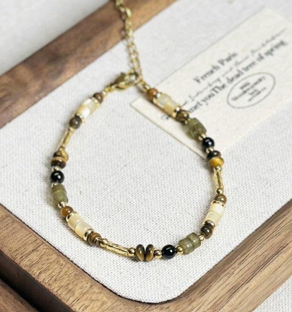 Pulsera con ágata negra y ojo de tigre en concha